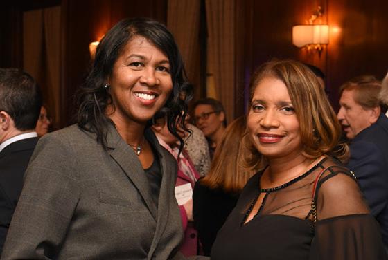 Photo of two women posing for the camera at a networking event