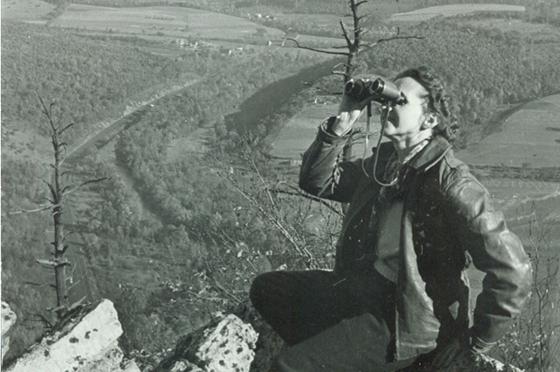 Photo of Rachel Carson, in black and white, looking through binoculars
